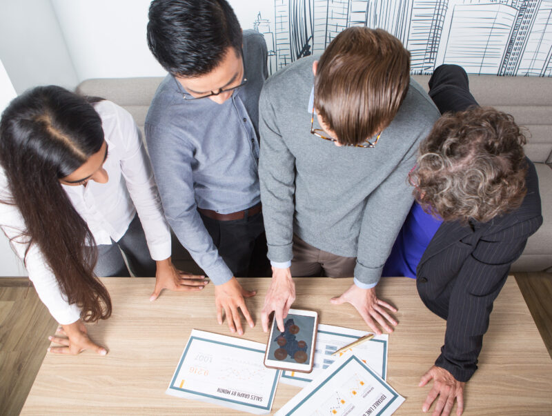 Four Business Colleagues Discussing Diagrams