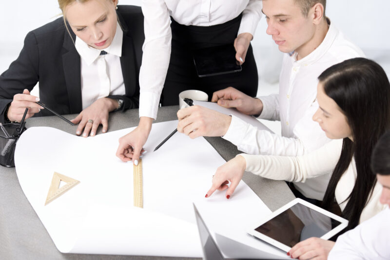group businessman businesswoman planning project paper desk